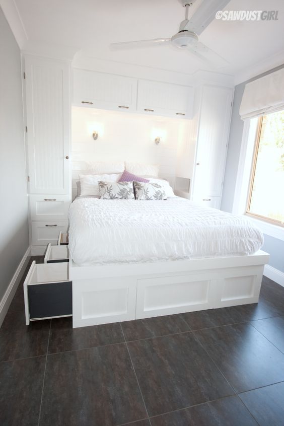 a built-in white bed with storage drawers in the sides of the bed is a cool solution and storage units on both sides of it will add storage space