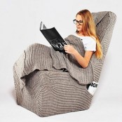 a cozy and comfy chair with a knit cover that includes a blanket seems to be a dream for cold months