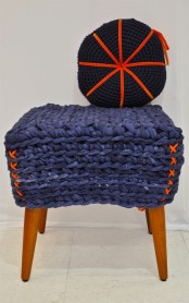a navy crocheted stool with a colorful pillow will be a cool solution for your entryway, living room or sunroom