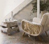 a mid-century modern chair with a white crochet cover and tassels is a lovely idea that will cozy you up