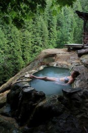 an outdoor bathtub cut out right in the stone is a gorgeously natural idea, especially when you have such a view