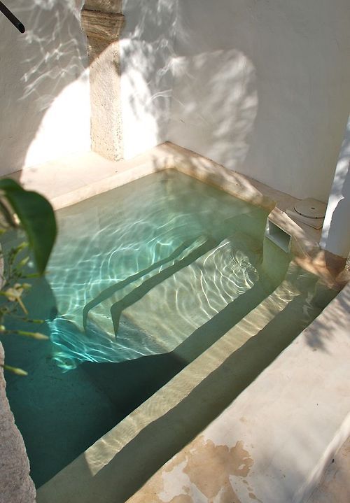 such a shallow outdoor pool or bathtub with steps is a great oasis for relaxation on a hot summer day