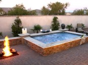 a large outdoor jacuzzi with candles and a fire pit next to it is relaxation with two elements – fire and water