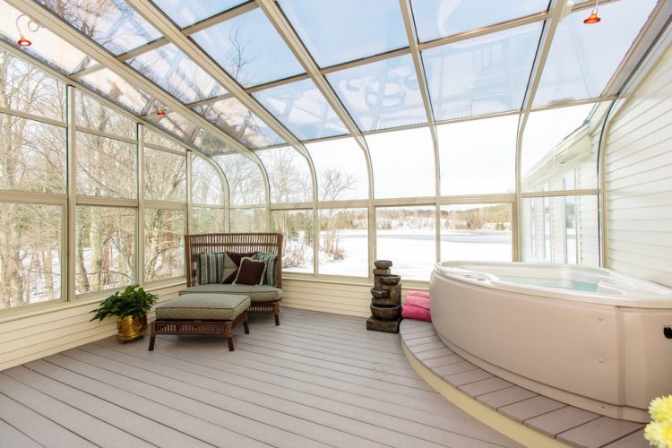 spacious four seasons sunroom with skylight and jacuzzi