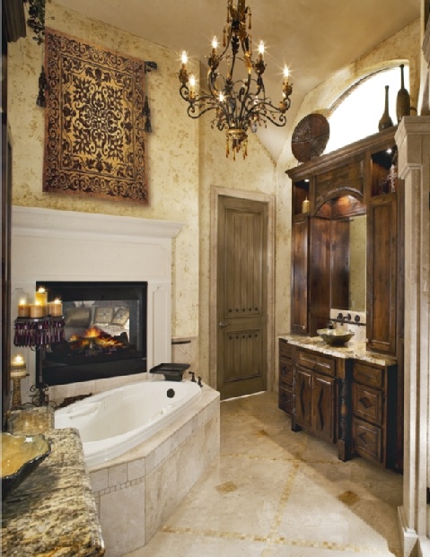 an eclectic bathroom with dark-stained wooden storage, a built-in fireplace, a bathtub clad with tiles, a vintage chandelier and candles