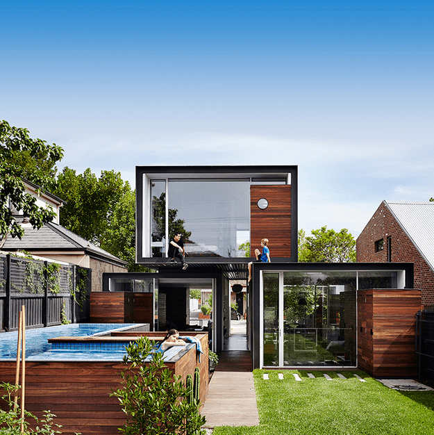 Stacked Volumes Home With Moving Walls And Raised Pool