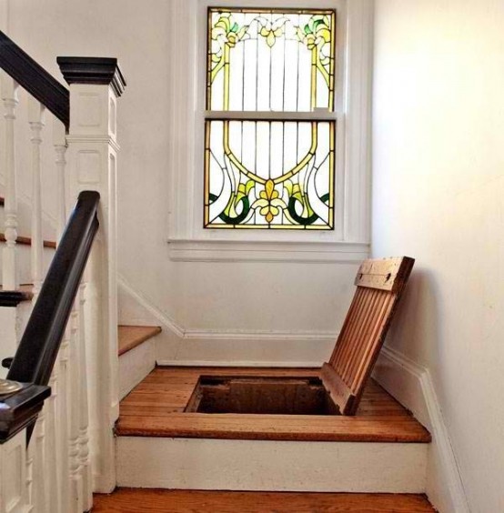 a staircase with storage and a stained glass window is a lovely idea for a modern and not only modern space, it makes it eye-catchy