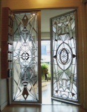 stained glass doors look very delicate, intricate and chic and keep privacy of the space and flood the space with light a lot