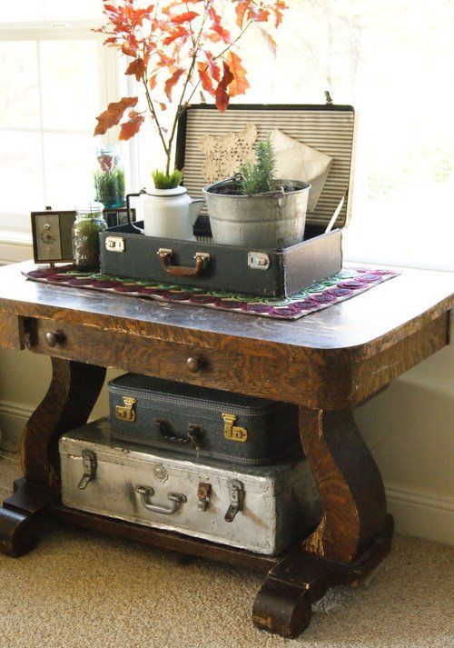 a console table with two suitcases inside it for storing some things that you don't want to show off
