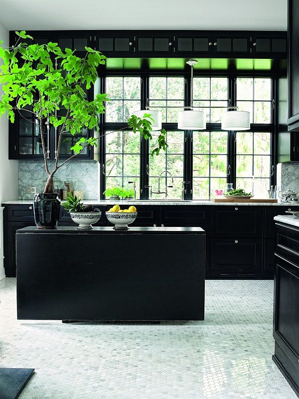a modern black kitchen with profiled cabinets, a kitchen island, a large window, a potted plant and a white floor that refresh the space