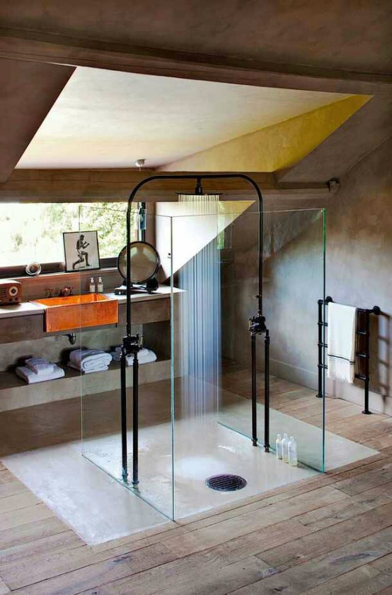 a minimalist industrial bathroom done with concrete and wood, with a skylight, a catchy shower soace and a concrete vanity with an orange sink