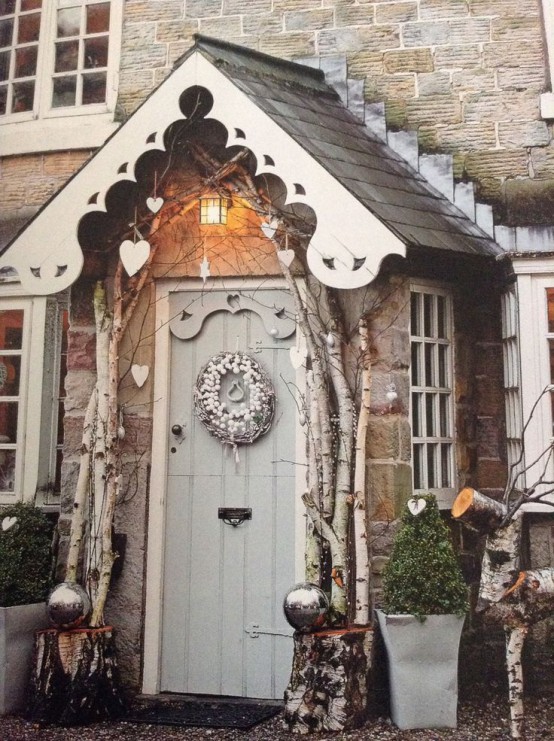 tall branches framing the door, hearts, oversized silver ornaments and a cotton wreath with twigs for a whimsy look