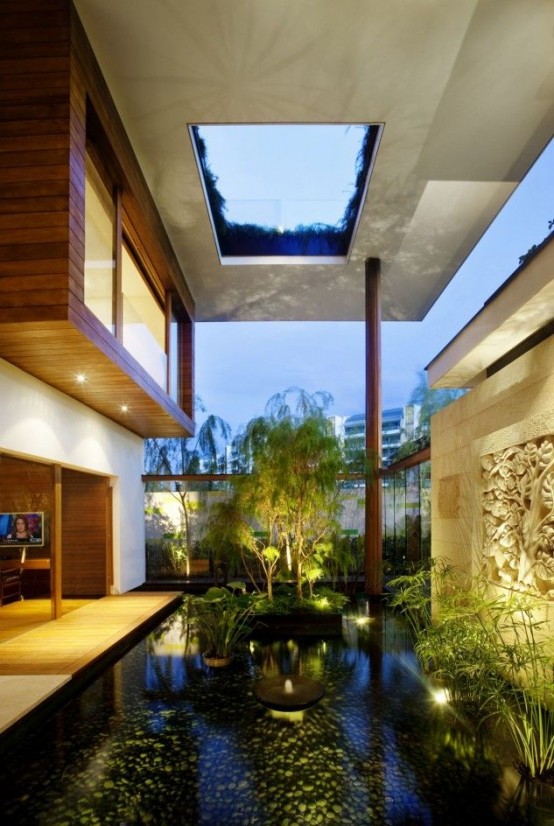 a whole water garden indoors - with a pond, lots of plants, artworks and some lights to accent it is a very zen space