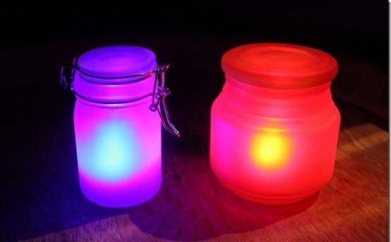 neon pink and orange jars with candles inside form lovely lanterns for Halloween decor and look awesome