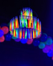 a Halloween chandelier made of test tubes with neon substances is a cool and fresh idea for a modern Halloween party