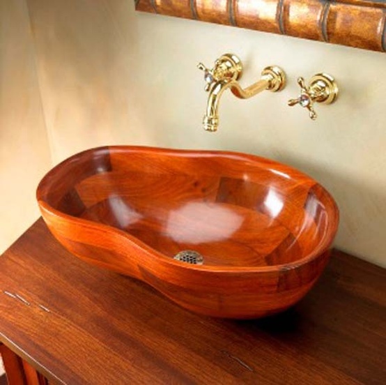 a rich-stained wooden vanity paired up with a wooven sink of a whimsical shape is a cool idea for a modern bathroom