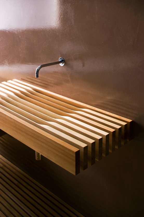 a very eye-catchy light stained wooden slab wall-mounted sink is a very unusual and very creative idea