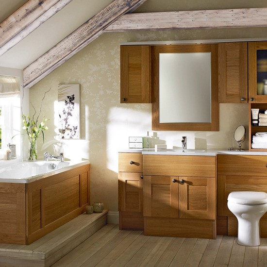 a modern rustic bathroom with wooden storage cabinets, white countertops and a sink, a bathtub clad with wood and wooden beams on the ceiling