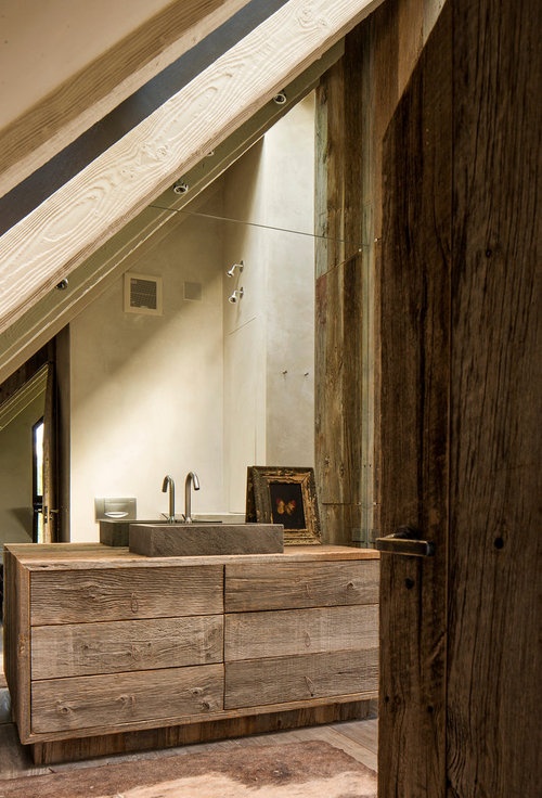 a cool bathroom with a rough wooden vanity and a concrete sink, wooden beams and a wooden floor is very wabi-sabi