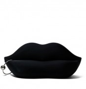 a black lip sofa with a hoop piercing is a catchy and bold idea for a modern space, it will make a statement