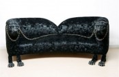a unique black sofa with pumas on both sides, with paws as legs and chain on top is a bold and catchy idea for a modern space