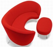 a red curved sofa with a matching footrest are a bold and catchy combo that will be welcomed in any modern space