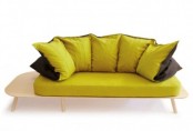 a modern sofa with a light-stained frame and yellow and black upholstery and pillows is a stylish and bright idea for a modern space