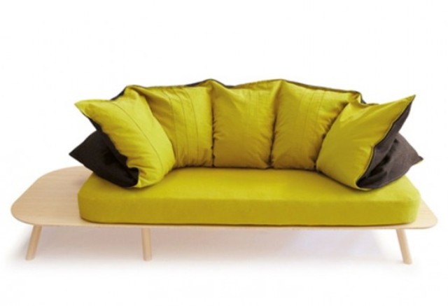 a modern sofa with a light stained frame and yellow and black upholstery and pillows is a stylish and bright idea for a modern space