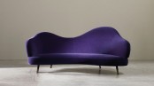 a bold violet sofa with a curved back is a stylish and catchy idea with plenty of color that will make a statement in your room