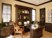 a vintage-inspired sandy and dark chocolate home office with stylish furniture, an amber leather chair and potted greenery