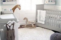 a pretty vintage-inspired nursery with light blue walls, grey furniture, neutral bedding, artwork and pendant lamps