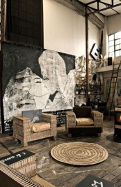 a weathered wood floor, an oversized artwork that takes the whole space and metal touches