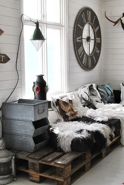 a pallet daybed, a vintage sconce and a stack of metal drawers for an industrial feel