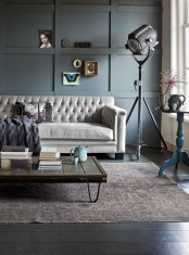 a contemporary living room with an industrial feel, a wood table with hairpin legs and a vintage metal lamp