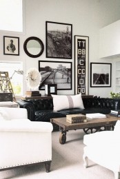 a black leather sofa, an industrial coffee table of wood placed on wheels and vintage lamps create an industrial living space