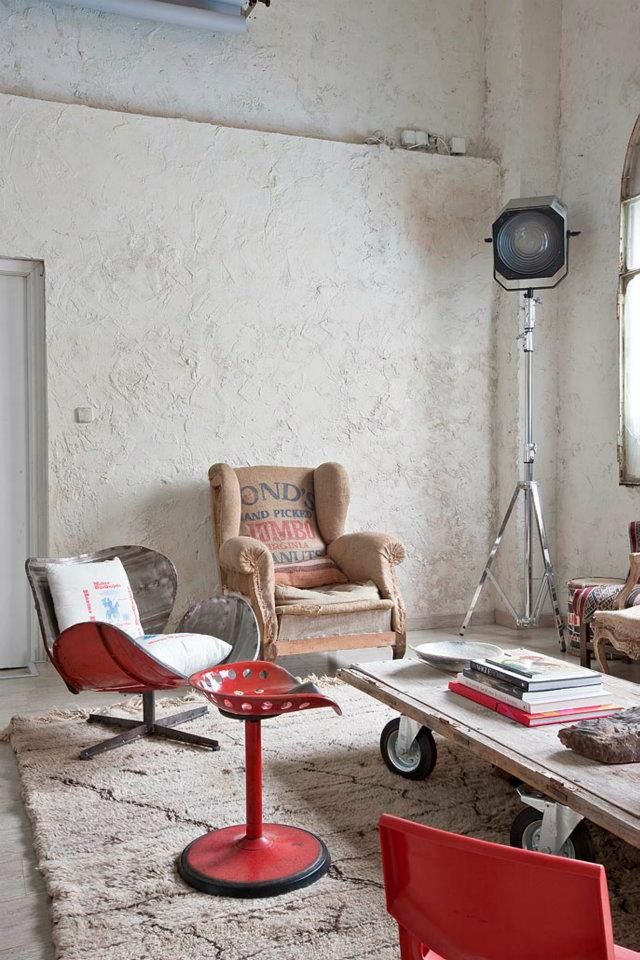 colorful metal furniture, a tall floor lamp and a wooden coffee table on wheels