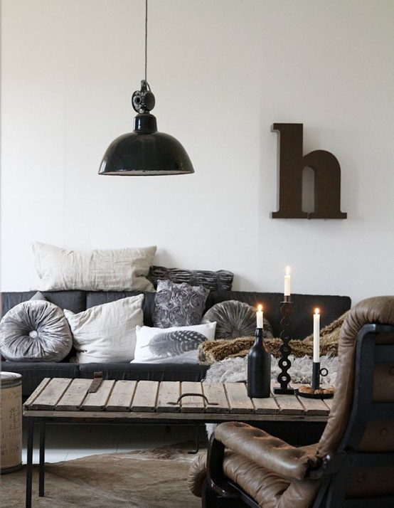 leather furniture, a wooden table on metal legs and a retro lamp to create a cool industrial feel