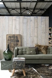 weathered wood walls, a metal chest and an industrial artwork for slight industrial touches