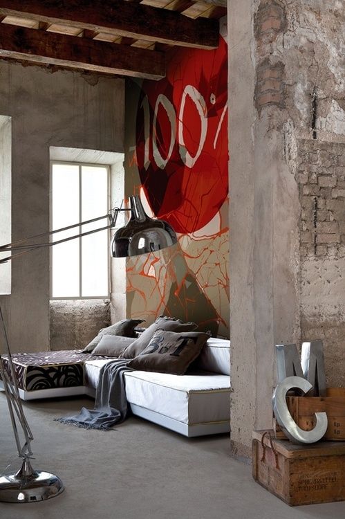 concrete walls and a floor, touches of brick and a retro floor lamp make up an industrial space