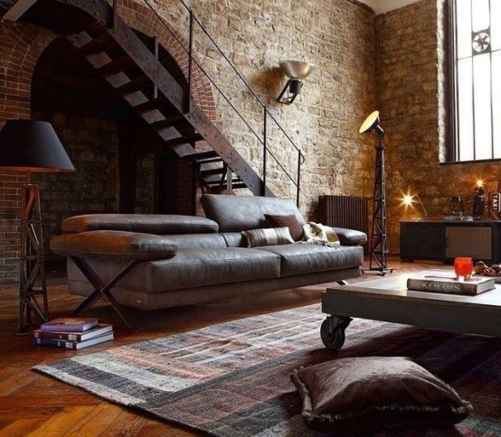 stone walls, vintage metal lamps, a metal and wood coffee table and comfy leather sofa