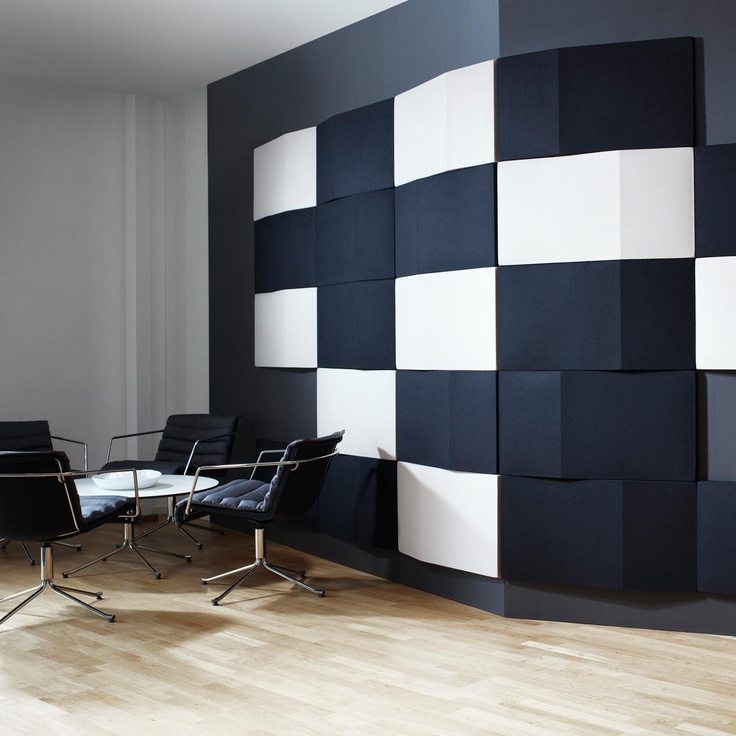 bold black and white rectangular tiles create a contrasting artwork on the wall