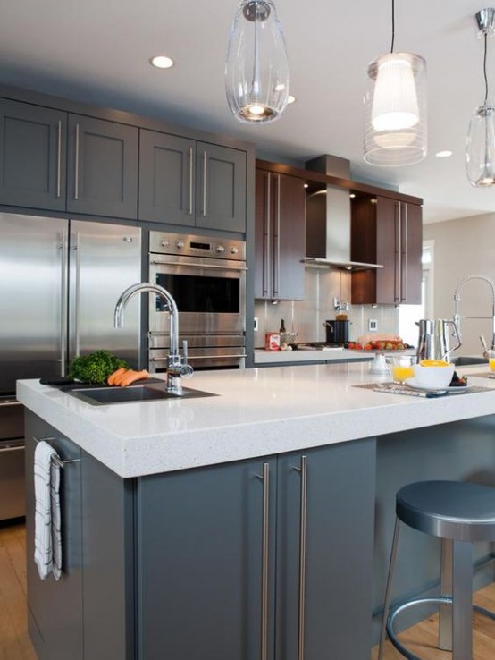 a grey and rich-stained mid-century modern kitchen with white countertops, pendant lamps and metal stools