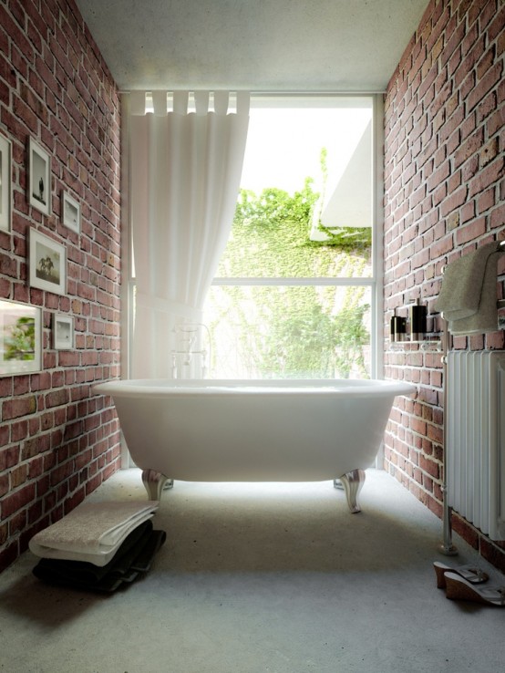 a gorgeous small bathroom with red brick walls, a glazed wall, a vintage-inspired tub and a gallery wall