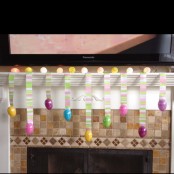 colorful fake Easter eggs hanging on bright masking tape is a simple Easter decor idea