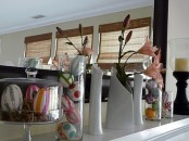 colorful fake eggs in cloches and pink lilies in vases for a fresh Easter look