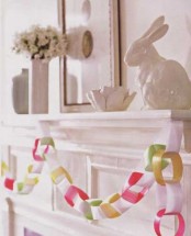 a colorful paper chain garland, an egg artwork and a porcelain bunny for an Easter touch