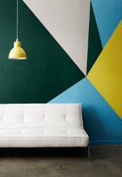 a colorful and contrasting geometric print accent wall, a white leather couch for a contrast