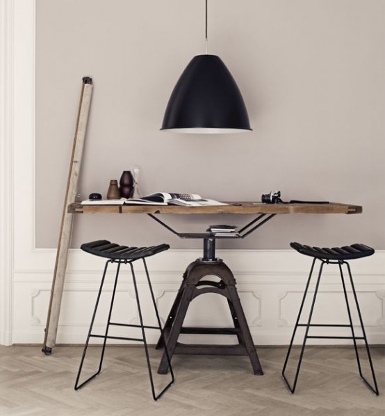 an industrial desk of a metal leg base and a folding wooden desktop is a nice idea for an industrial space, and it can be also rocked as a dining table