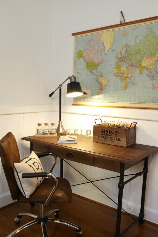a pretty and small home office with a map on the wall, a metal pipe and wood desk, a leather chair for a lovely and cozy nook