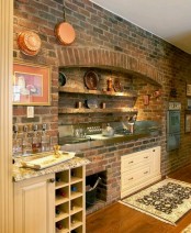 an original brick wall exposed sets the tone in the kitchen making it industrial, vintage and rustic at the same time